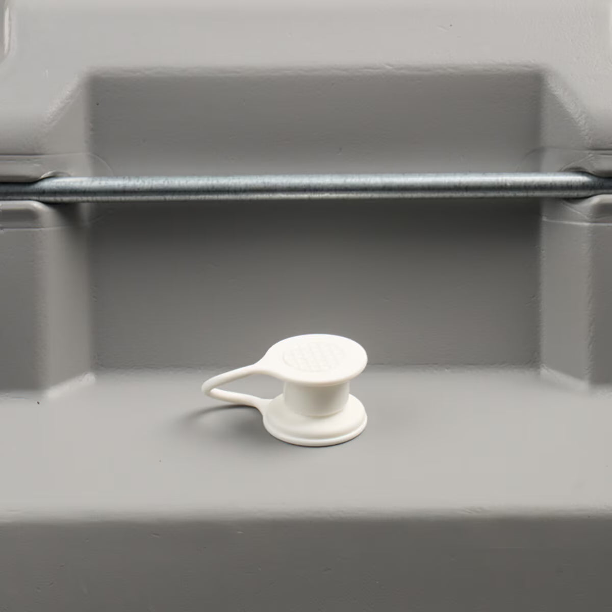 White plastic drain plug for camper van water tank or outdoor storage bin