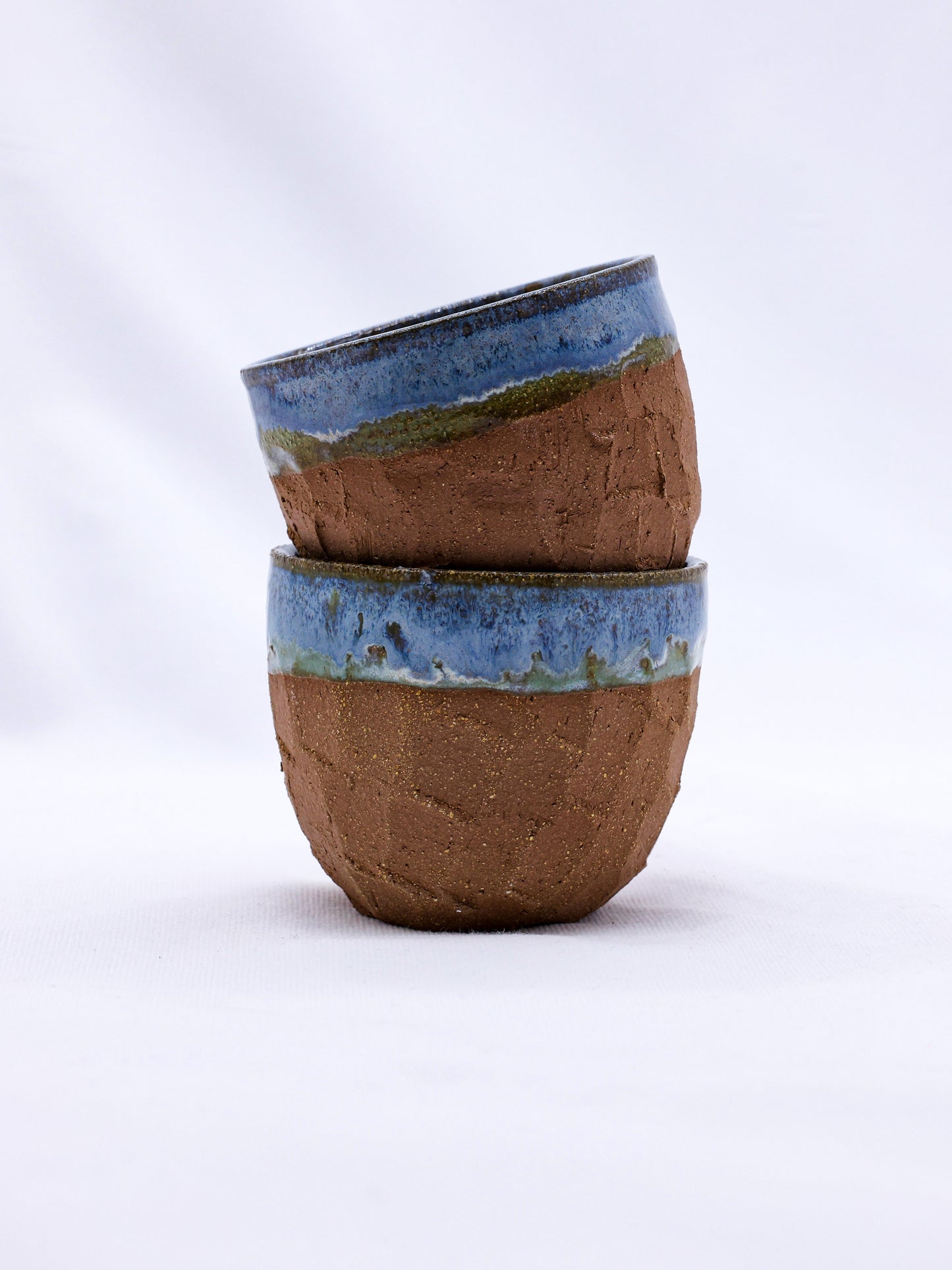 Handmade ceramic bowls with blue and earthy glaze, perfect for van life essentials and outdoor adventures.
