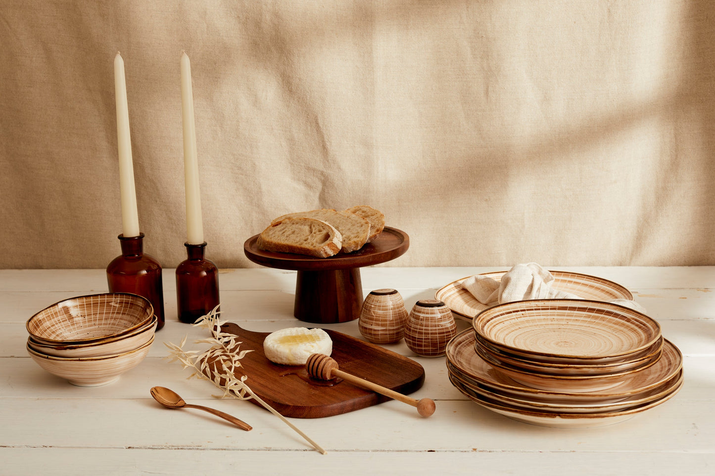 Rustic ceramic dinnerware set with wooden accents, perfect for van life and outdoor dining adventures