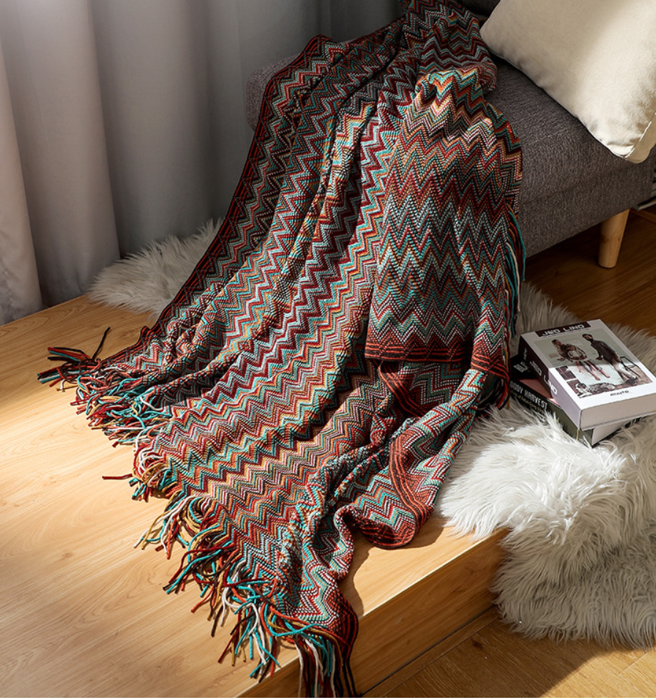 Colorful zigzag patterned throw blanket with fringe, perfect for van life cozy interiors and outdoor adventures.