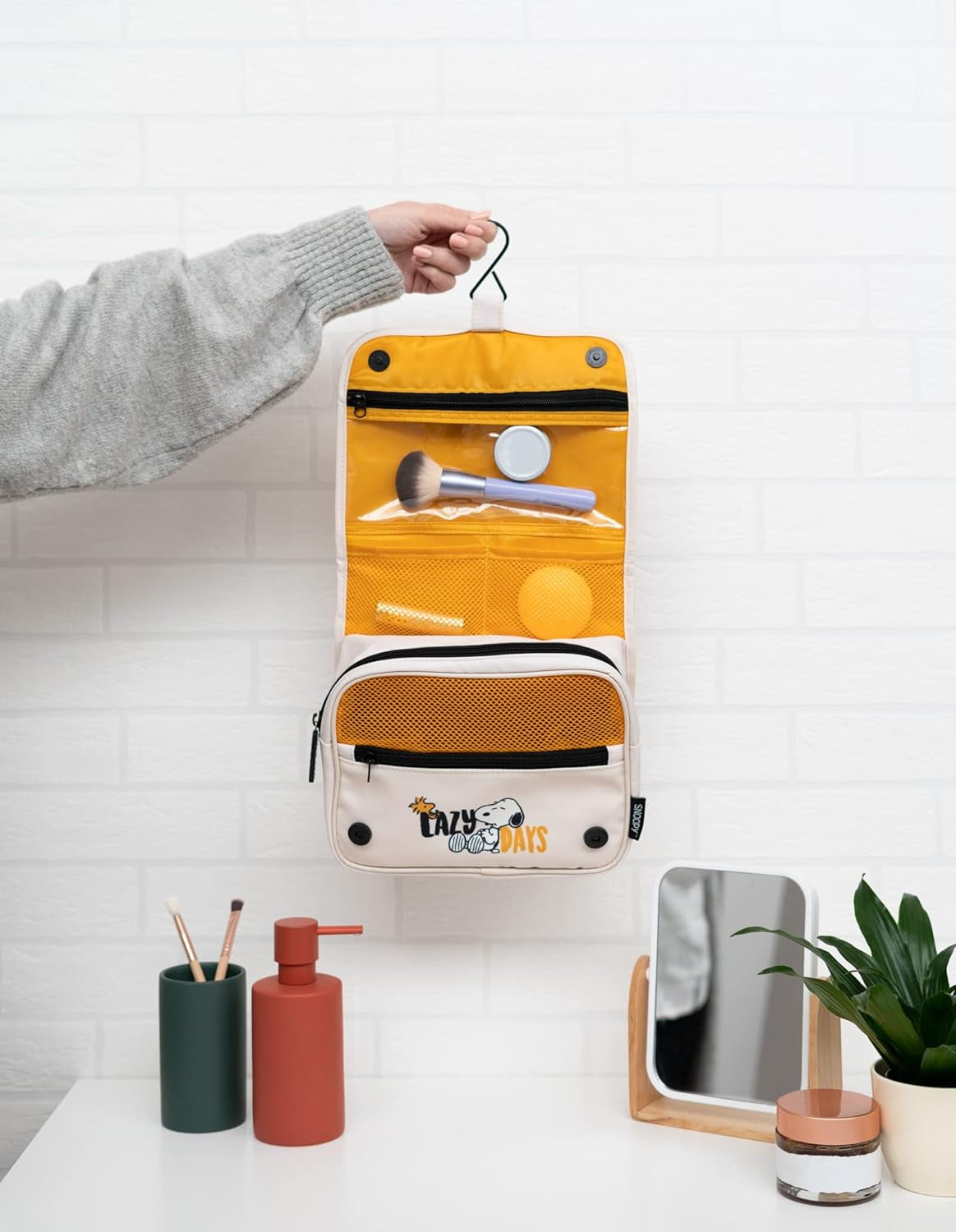 Yellow hanging toiletry bag with Snoopy 'Lazy Days' print, perfect for van life organization and travel essentials.