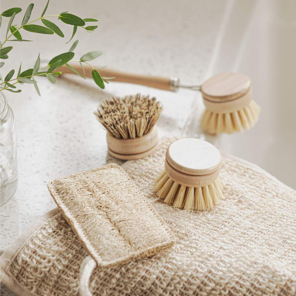 Eco-friendly bamboo brushes and loofah sponge for van life bathroom essentials