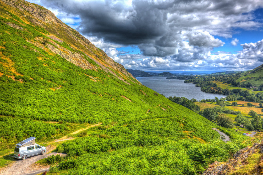 Campervan overlooking a lake and green fells in Northern England