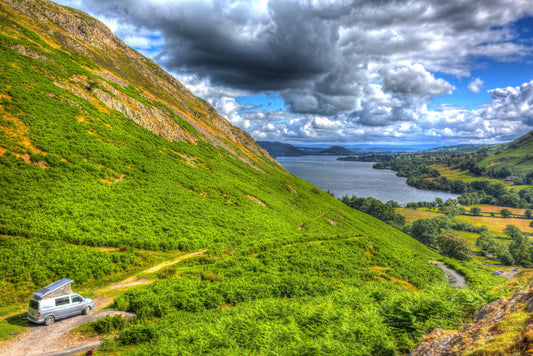 Campervan overlooking a lake and green fells in Northern England
