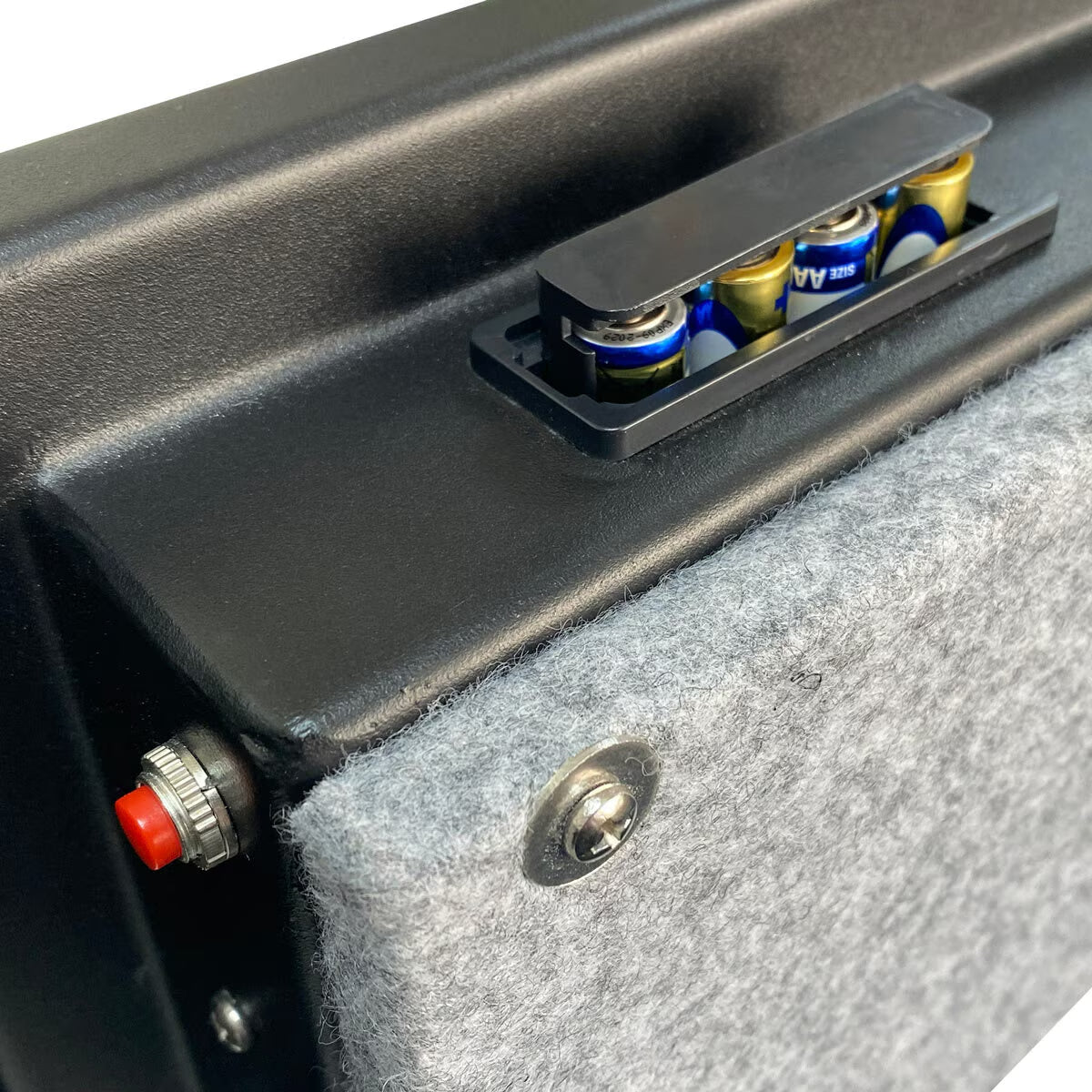 Black portable speaker with AA battery compartment, red power knob, and grey felt cover for van life adventures