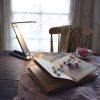 Cozy van life reading nook with book, lamp, and soft lighting for campers and adventurers