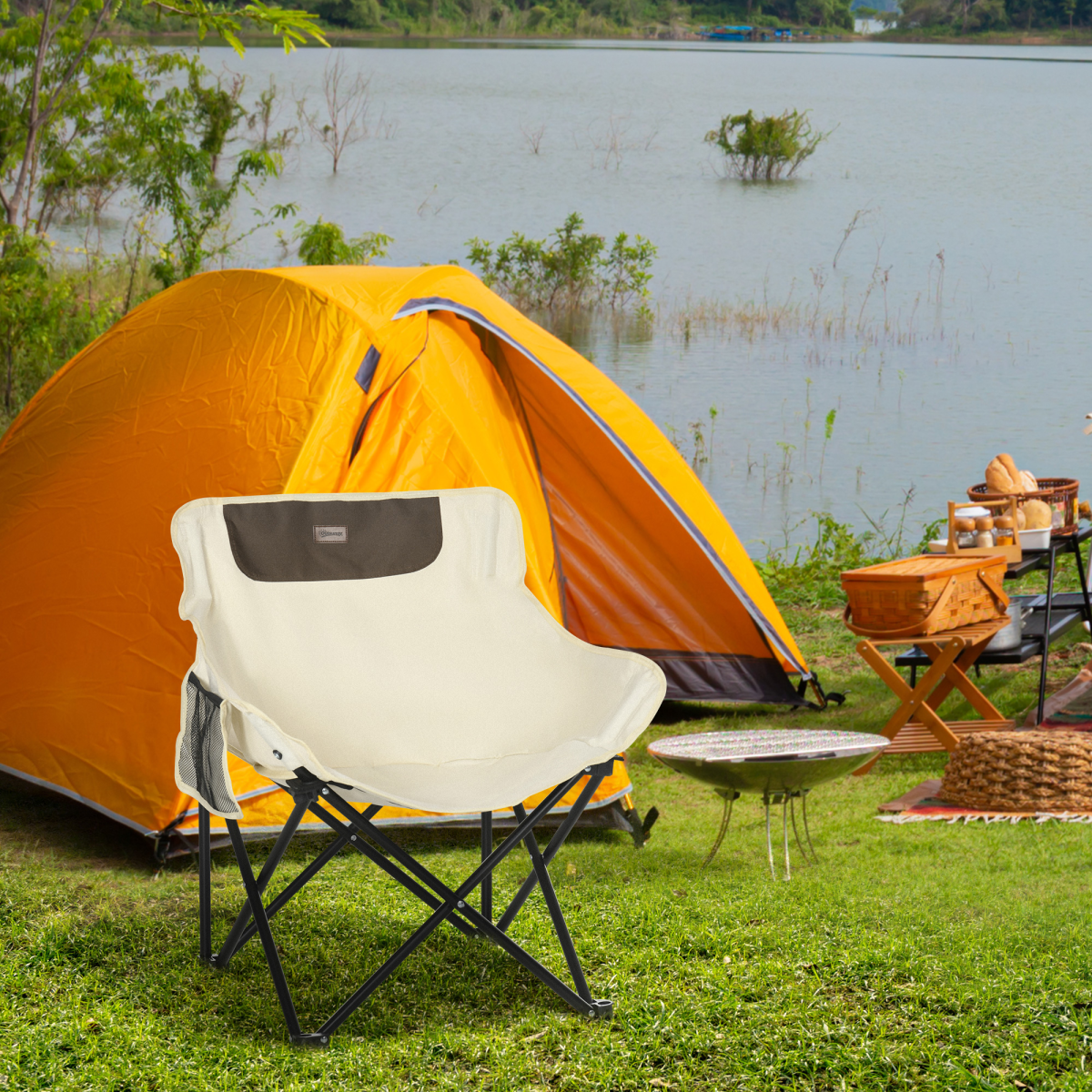 Portable camping chair by orange tent near lake, perfect for van life and outdoor adventures