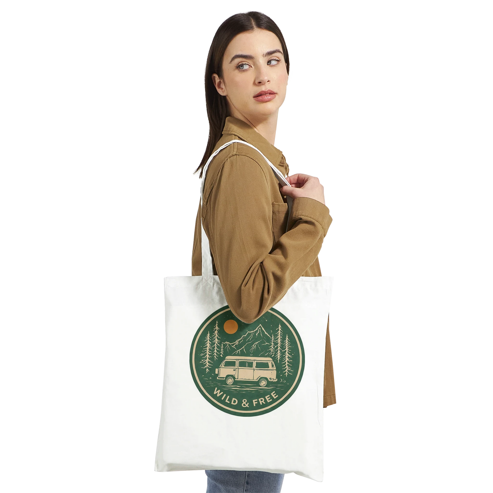 White canvas tote bag with 'Wild & Free' van life design, featuring camper van, mountains, and trees for outdoor adventures.