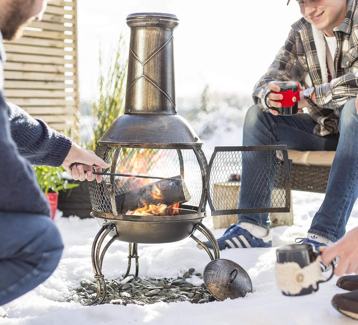 La Hacienda Leon Steel Chiminea – Bronze Effect – chiminea at an outdoor gathering