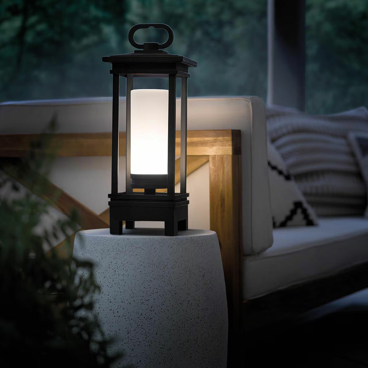 Black outdoor lantern glowing softly on patio, perfect for van life camping and outdoor adventures