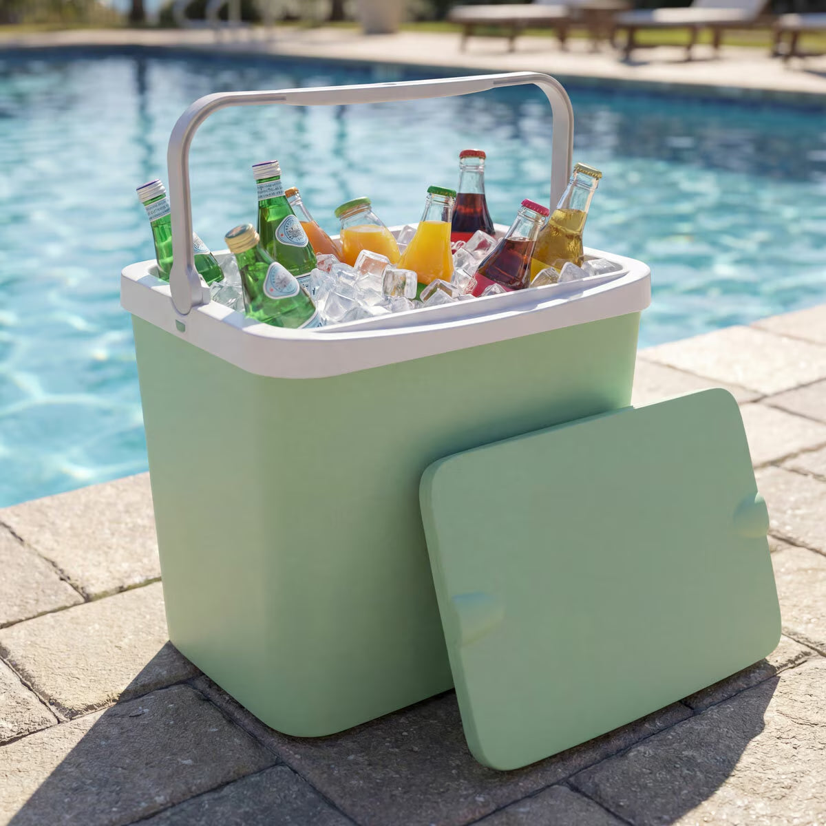 Mint green portable cooler with drinks and ice by poolside, perfect for van life adventures and outdoor gatherings