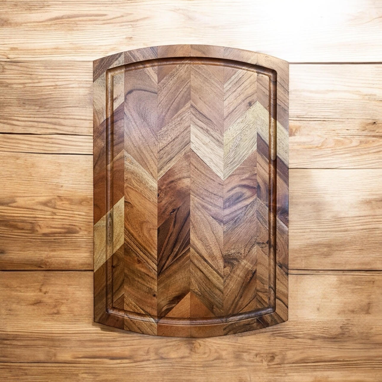 Wooden cutting board with herringbone pattern, ideal for van life kitchen essentials and outdoor adventures.