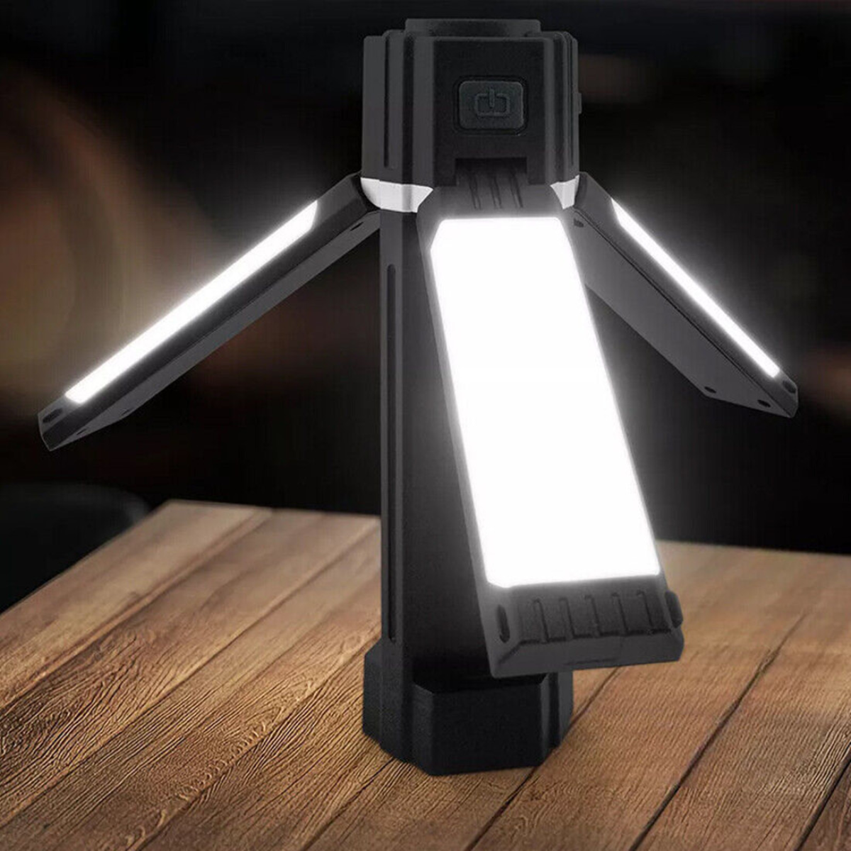 Portable LED camping lantern with tripod legs, ideal for van life and outdoor adventures