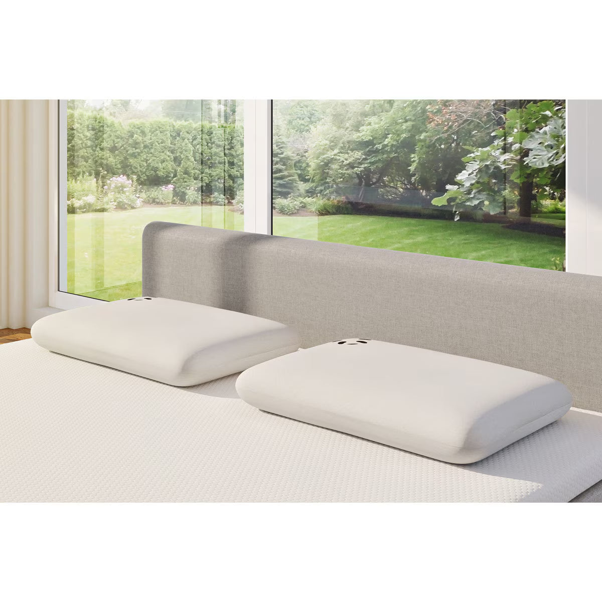 Two white memory foam pillows on a van bed with garden view, perfect for van life comfort and outdoor adventures.