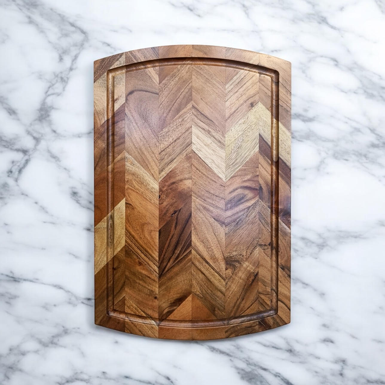 Wooden cutting board with herringbone pattern, ideal for van life kitchen essentials and outdoor adventures