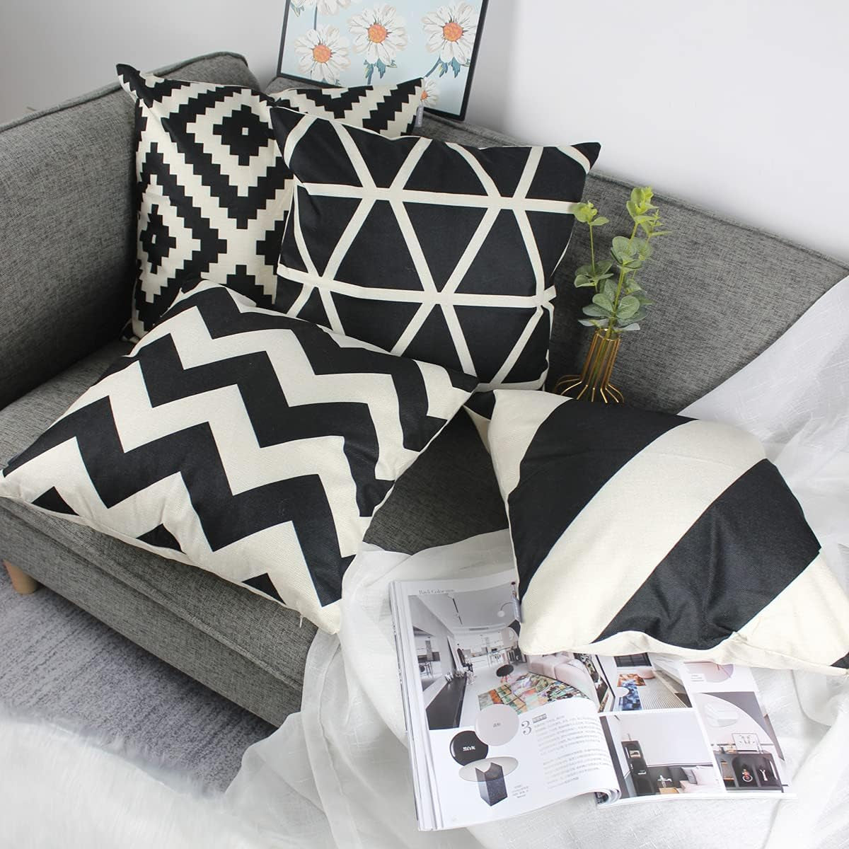 Black & Cream Geometric Cushion Covers – 4 Pack, 50cm – four geometric cushions on a sofa