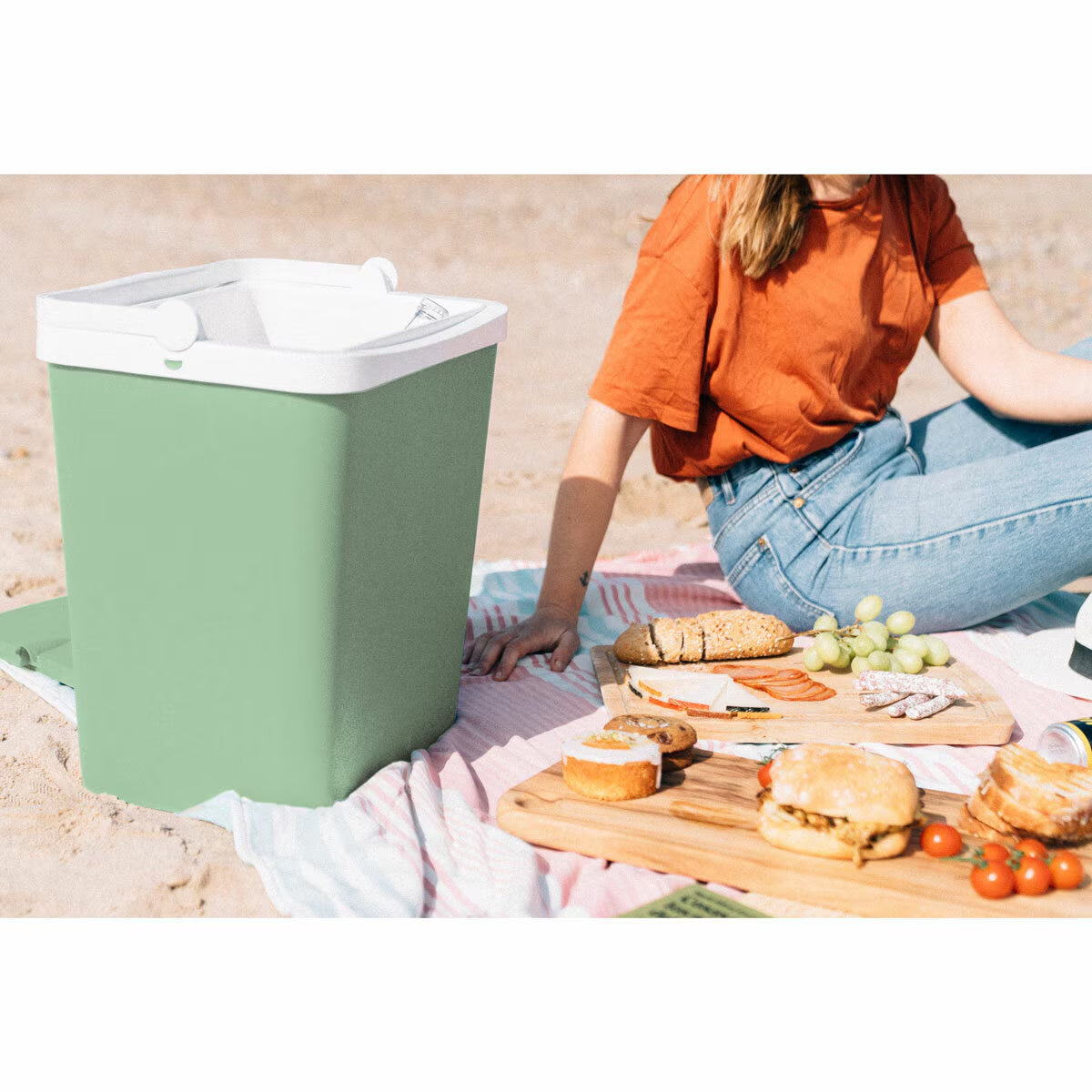 Green portable cooler for beach picnics, van life adventures, and outdoor meals with snacks and sandwiches