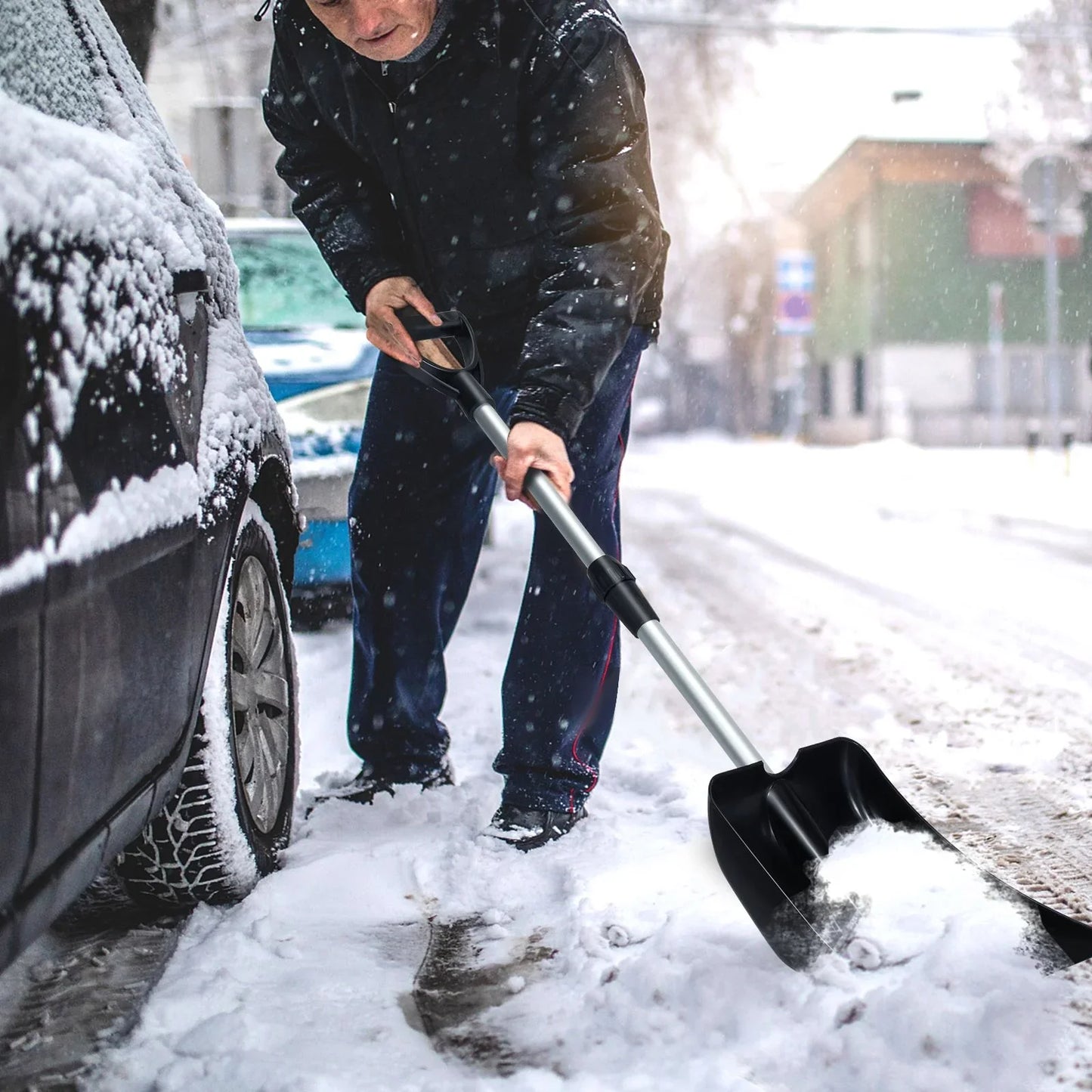 Man shoveling snow beside van with collapsible snow shovel for winter van life adventures