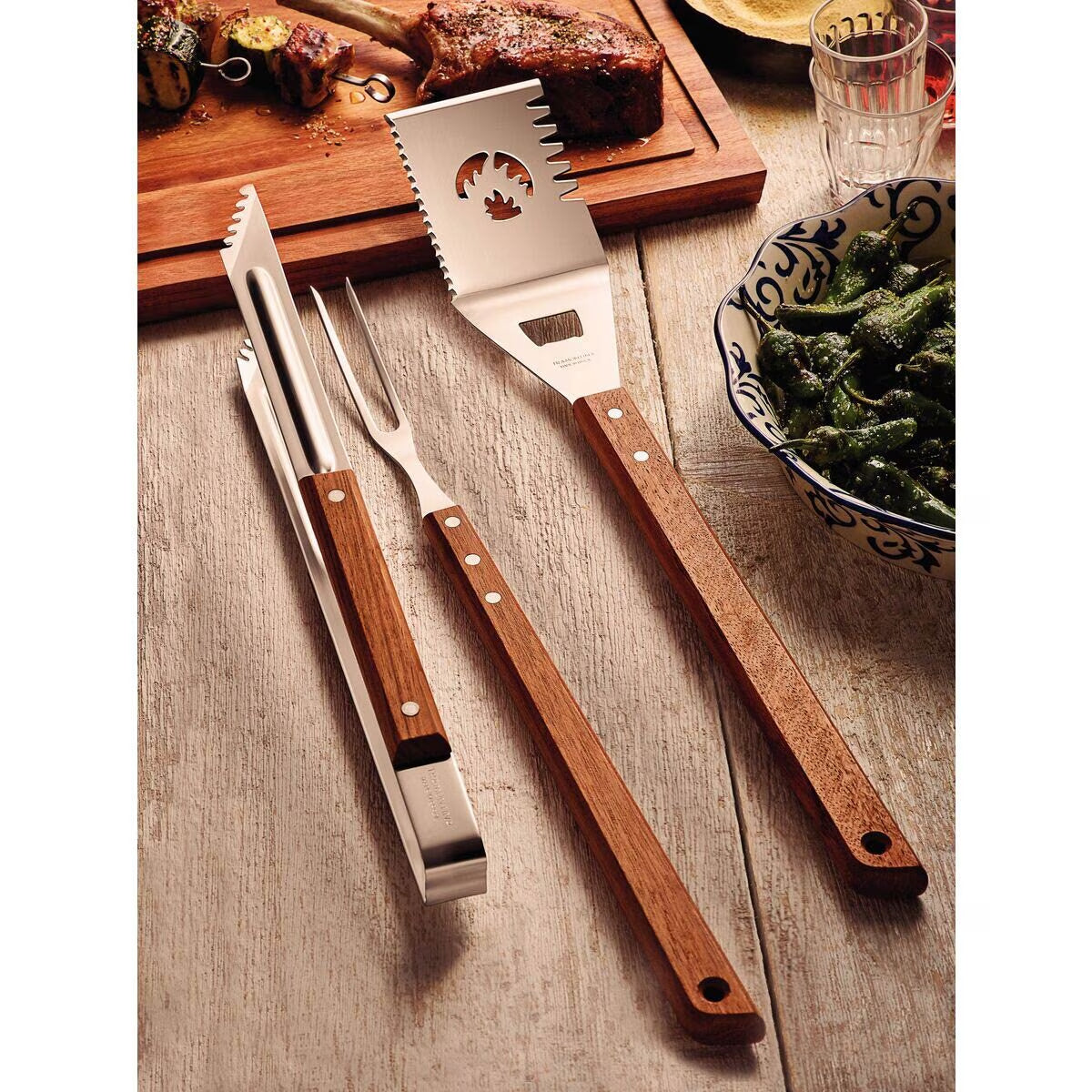 Stainless steel BBQ tools with wooden handles for outdoor grilling and van life adventures