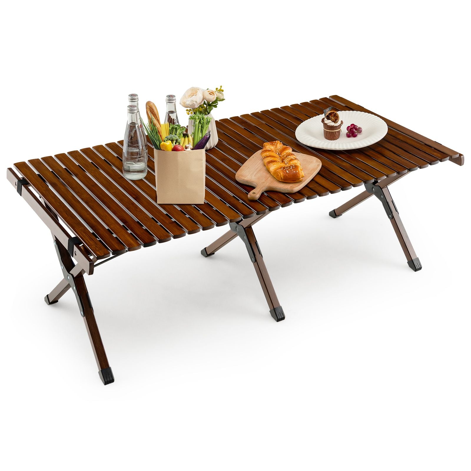 Portable folding camping table with wood slats, set with bread, water, and snacks for van life adventures