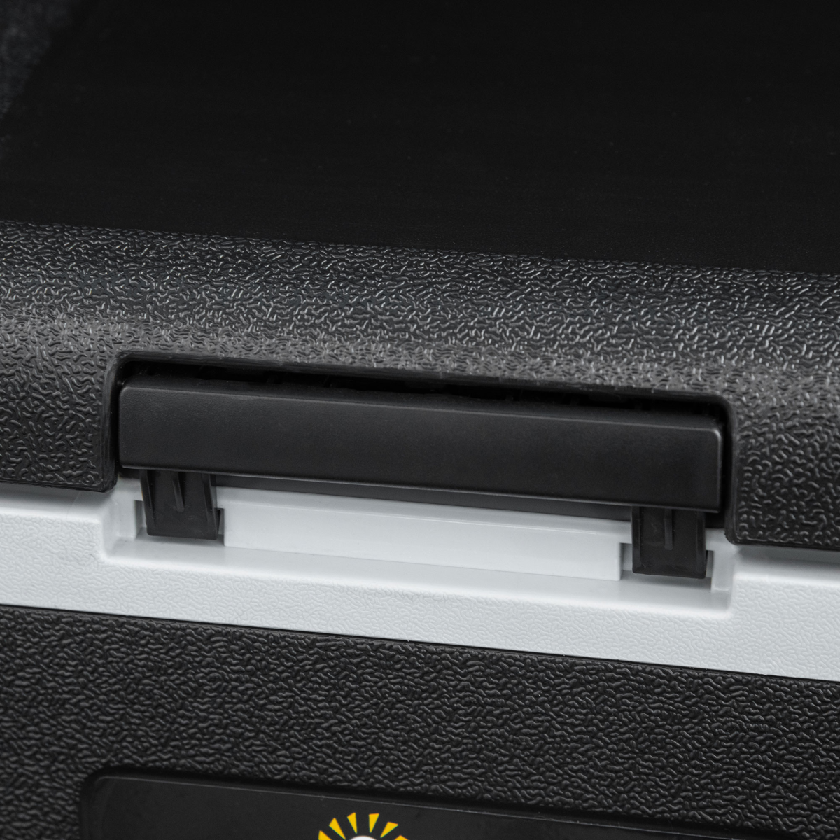 Close-up of rugged black and white portable cooler with secure latch for van life adventures