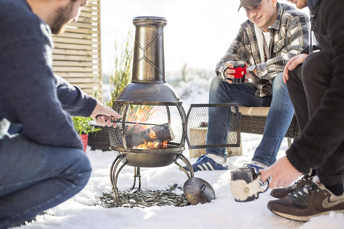 La Hacienda Leon Steel Chiminea – Bronze Effect – people sitting around an outdoor chiminea