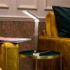 Modern LED desk lamp on side table beside yellow velvet sofa, ideal for van life interiors and cozy camping setups