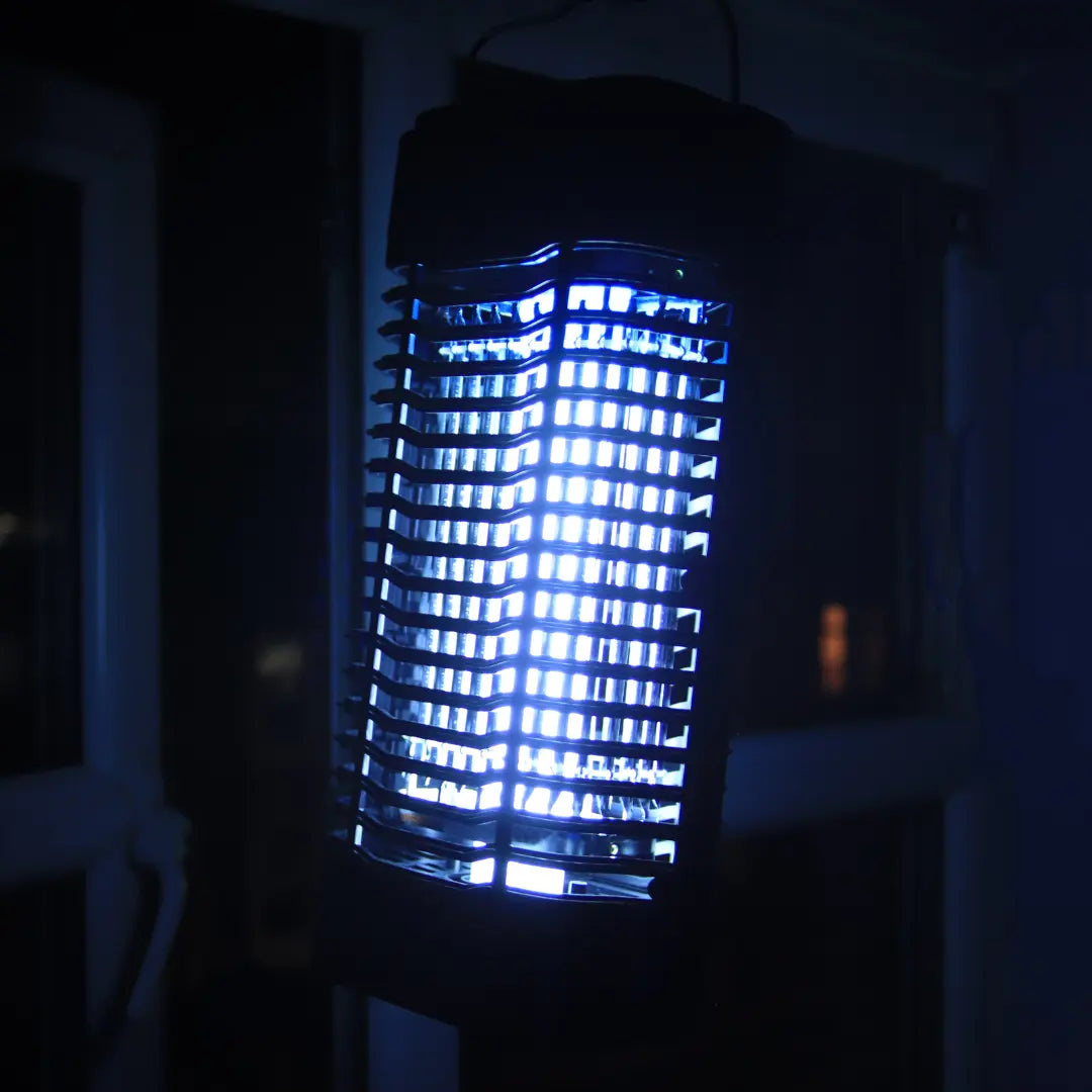 Portable UV bug zapper for van life, camping, and outdoor adventures glowing blue at night