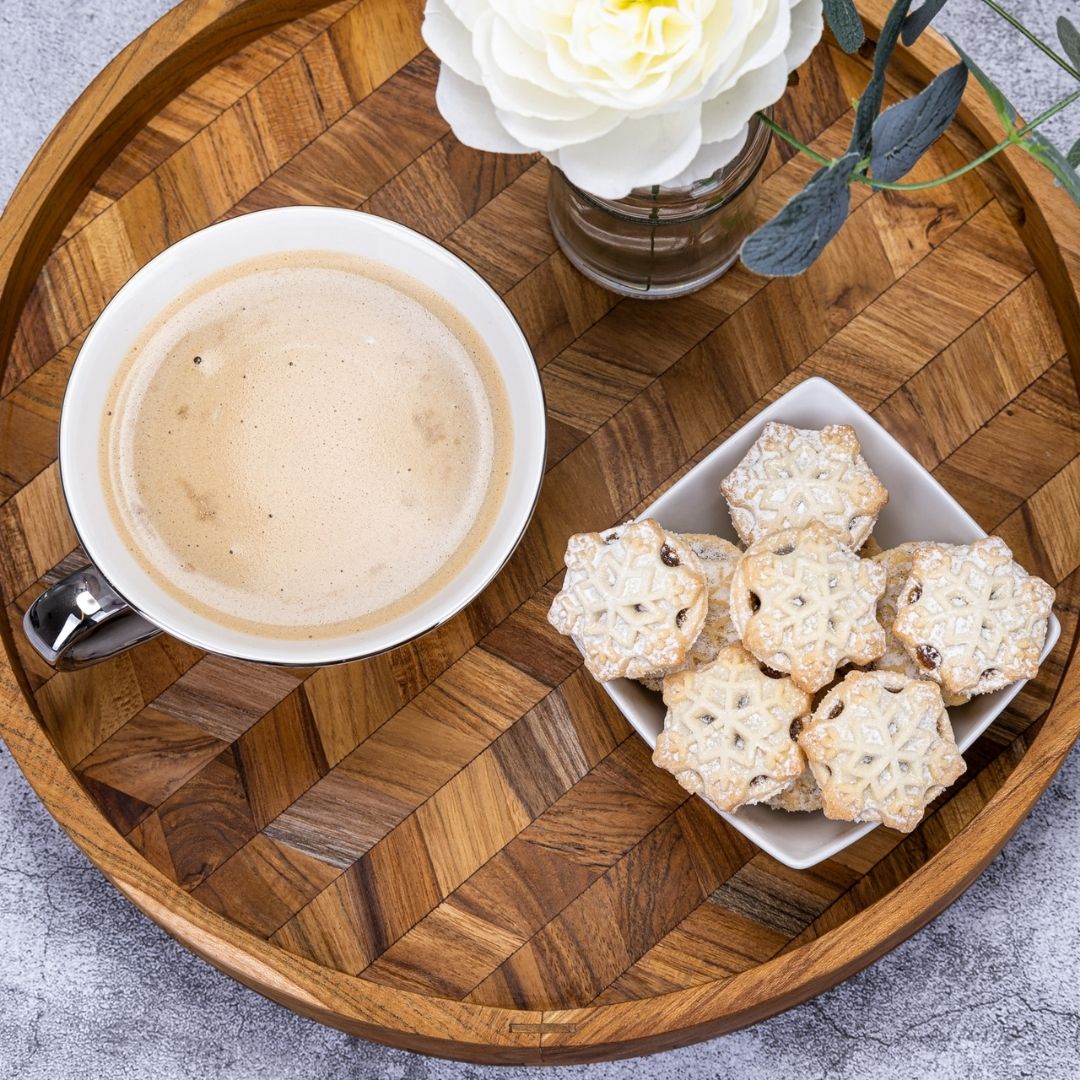 Wooden tray with coffee, biscuits, and white flower — perfect for van life cozy mornings