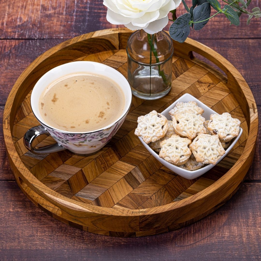 Wooden serving tray with coffee, snowflake cookies, and white rose — perfect for van life cozy moments