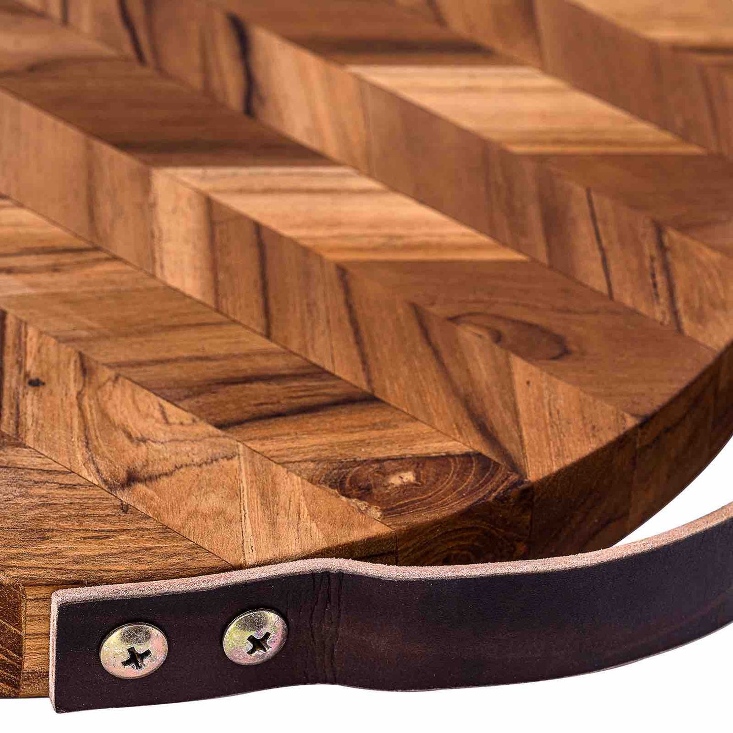 Solid wood cutting board with chevron pattern and leather handle, ideal for van life kitchens and outdoor cooking.