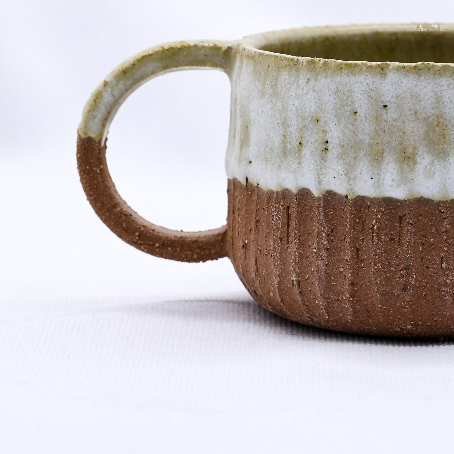 Handcrafted ceramic mug with rustic two-tone glaze, perfect for van life and outdoor adventures