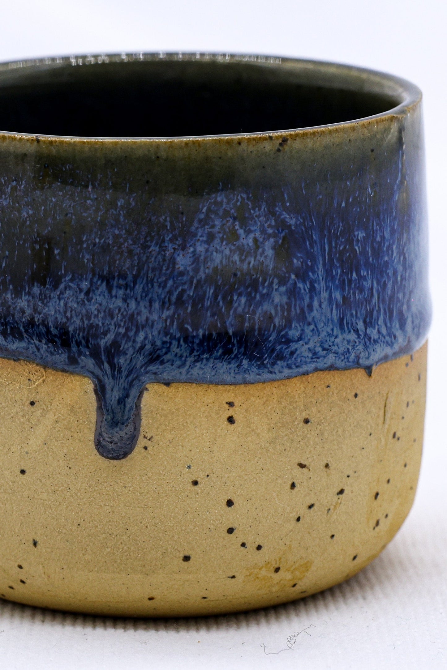 Handmade ceramic mug with blue drip glaze, perfect for van life and outdoor adventures.