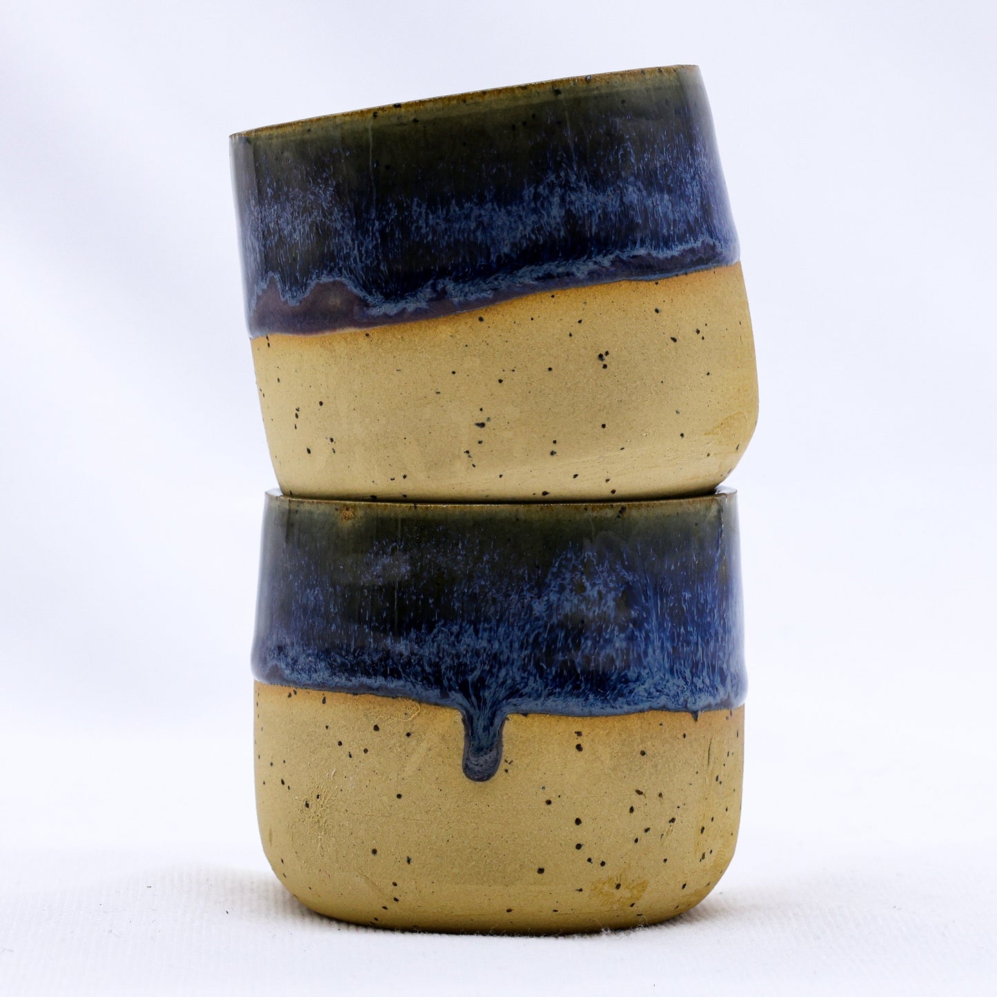 Handcrafted ceramic van life cups with blue drip glaze, perfect for camper van essentials and outdoor adventures.
