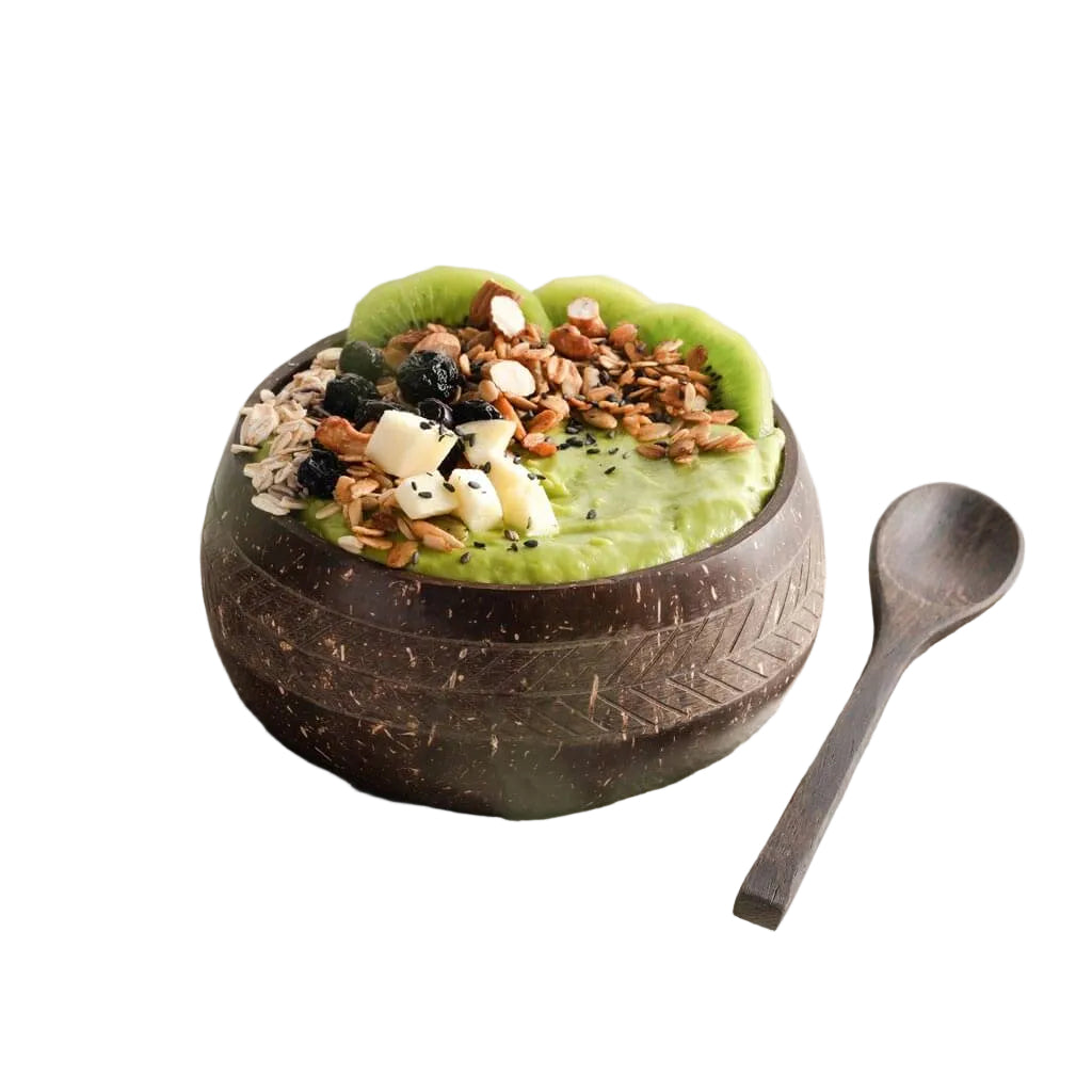 Coconut bowl with green smoothie, kiwi, granola, and wooden spoon — van life breakfast essentials