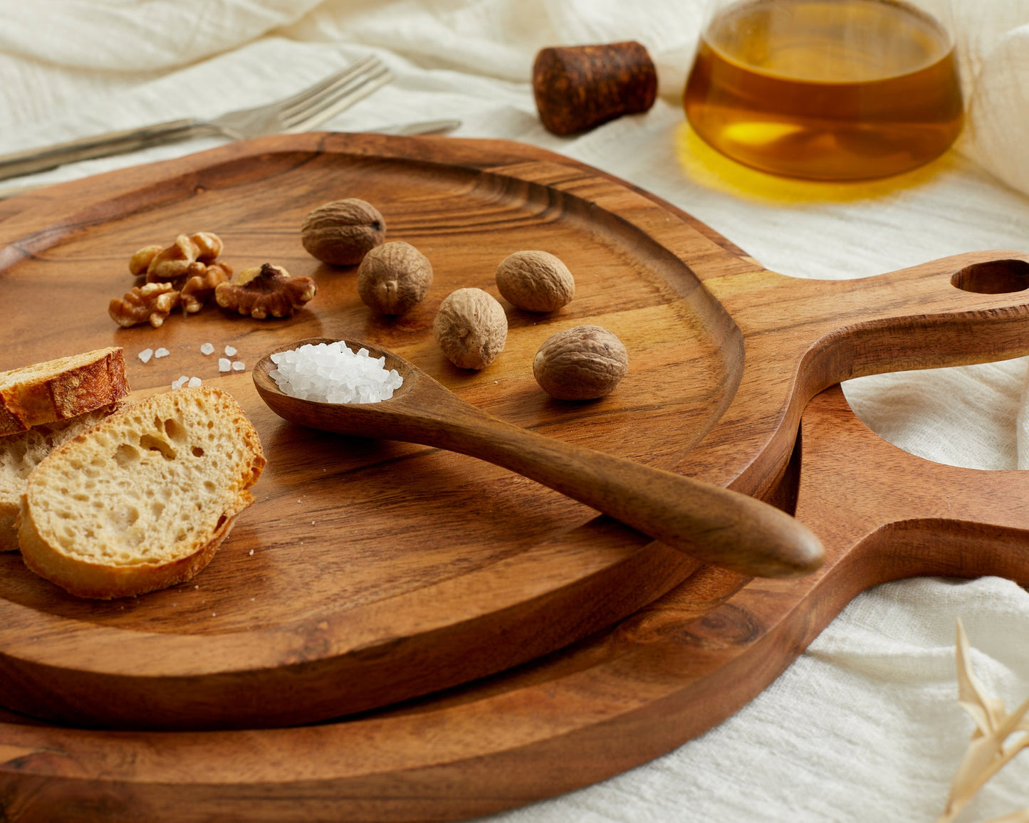 Wooden serving board with bread, walnuts, salt, and nuts — perfect for van life meals and outdoor picnics
