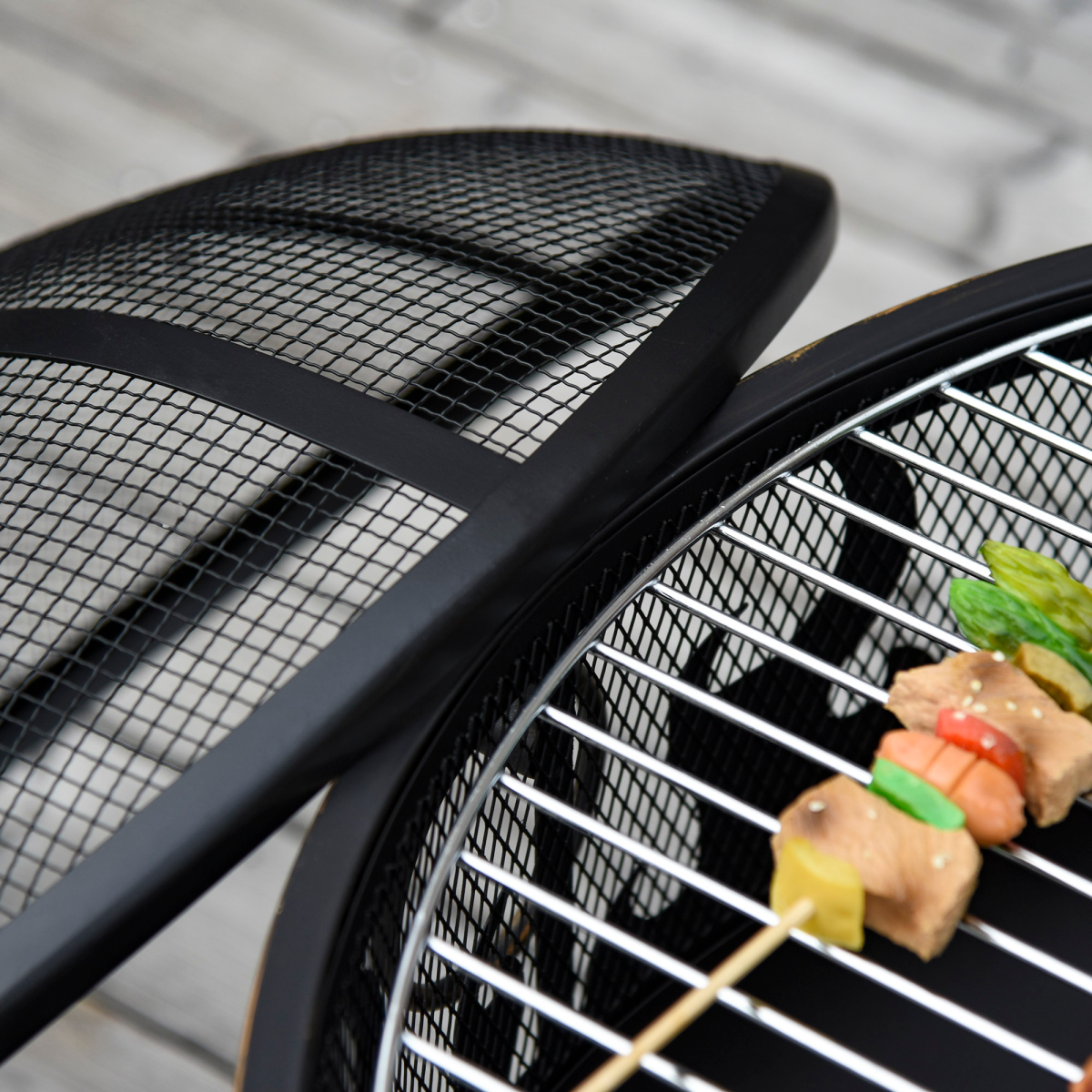 Portable charcoal grill with skewers grilling veggies and meat, perfect for van life camping adventures.