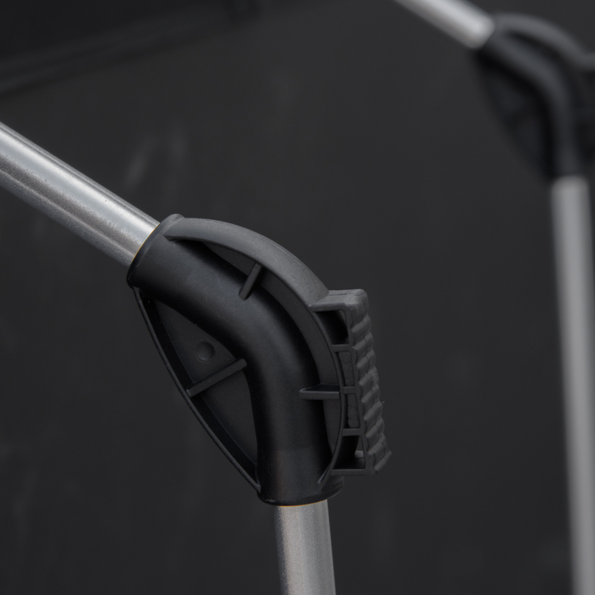 Black plastic clamp securing silver metal pole for van life gear setup