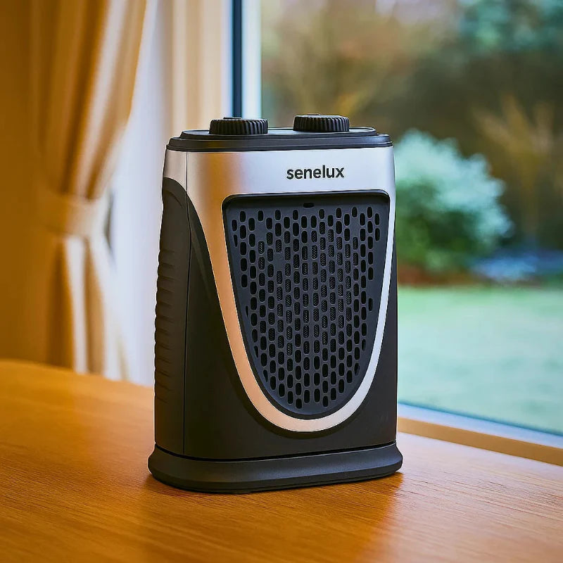 Senelux portable heater for van life, compact design on wooden table near window