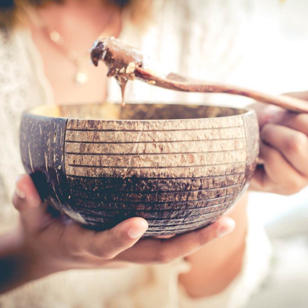 Coconut bowl with wooden spoon, perfect for van life meals and outdoor adventures