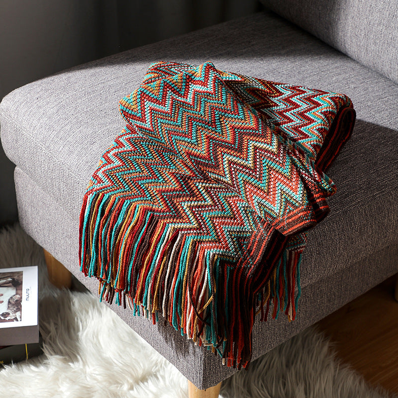 Colorful zigzag patterned throw blanket with fringe, perfect for van life cozy interiors and outdoor adventures.