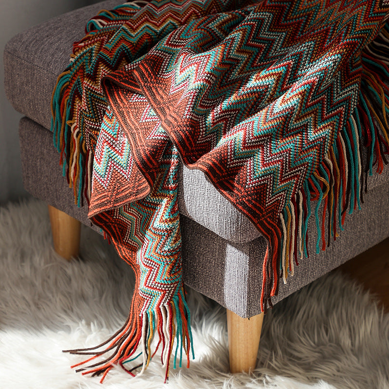 Colorful zigzag patterned throw blanket with fringe, perfect for van life cozy interiors and outdoor adventures.