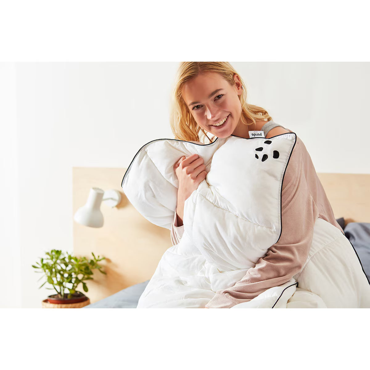 Cozy white weighted blanket with black trim, perfect for van life comfort and cozy nights