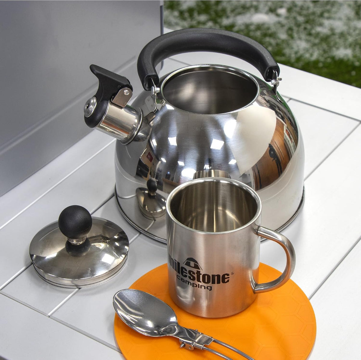 2L Stainless Steel Whistling Camping Kettle – kettle and mug on a camping table