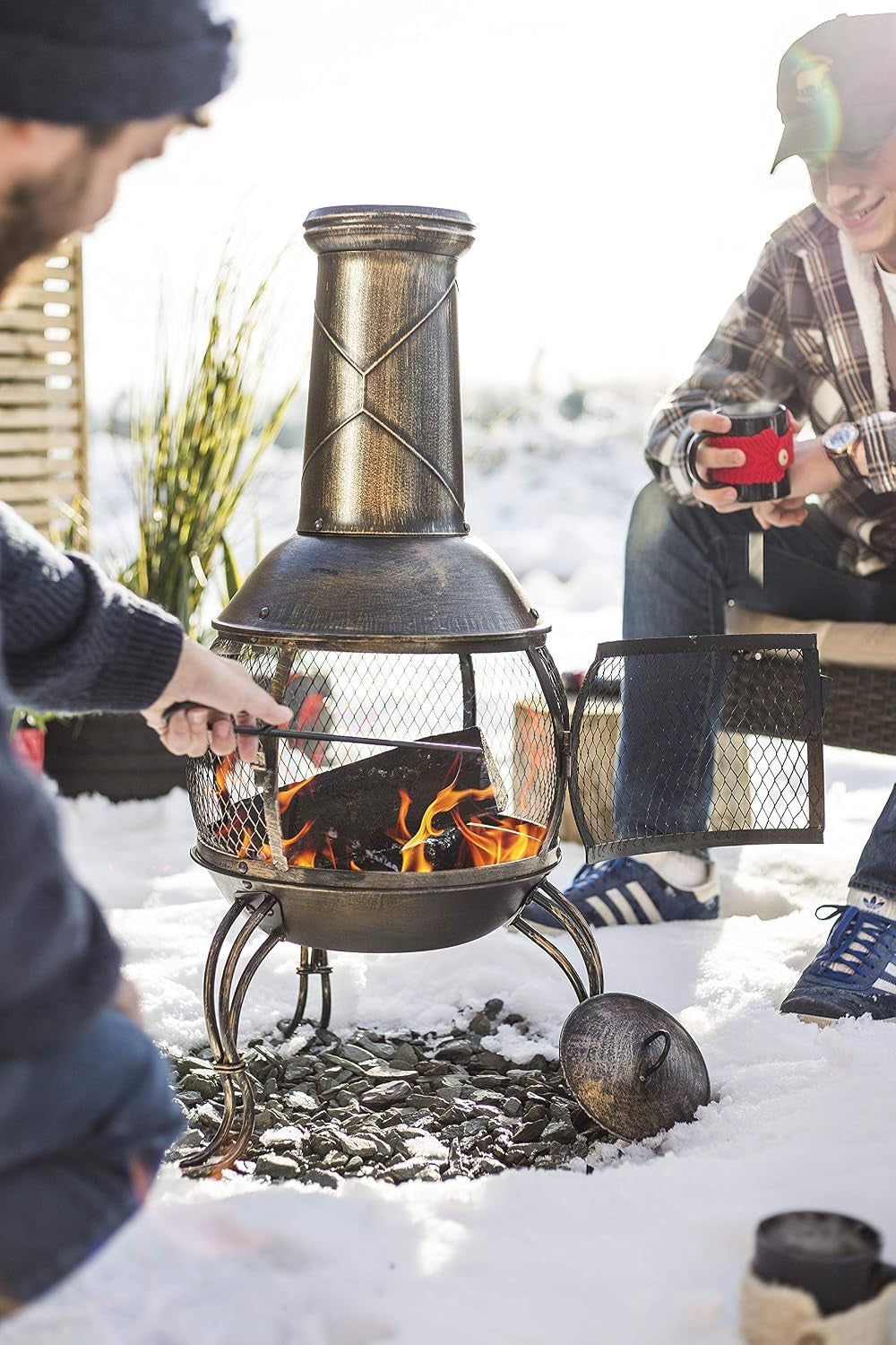 La Hacienda Leon Steel Chiminea – Bronze Effect – chiminea in use outdoors
