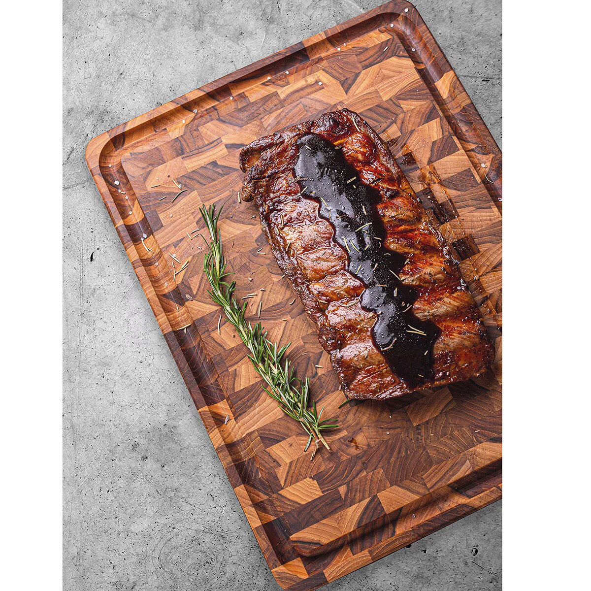 Grilled ribs with rosemary on a wooden cutting board for van life cooking
