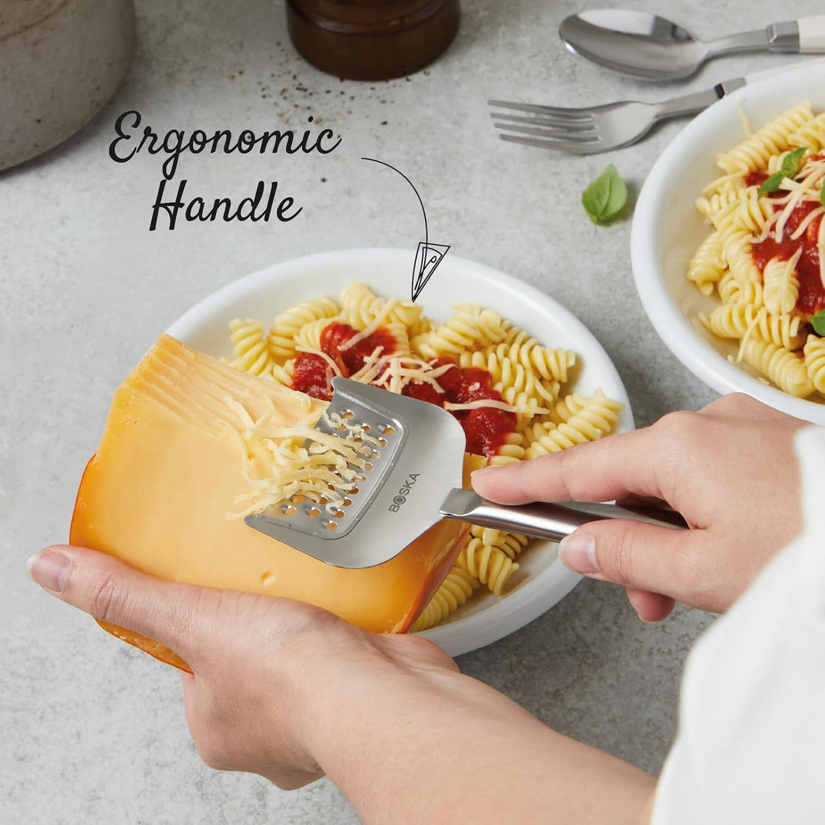 BOSKA Copenhagen Handheld Cheese Grater – grating cheese over a meal