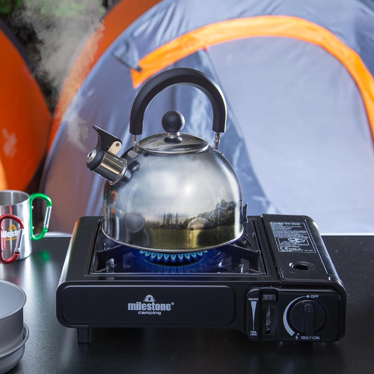 2L Stainless Steel Whistling Camping Kettle – kettle on a stove beside a tent