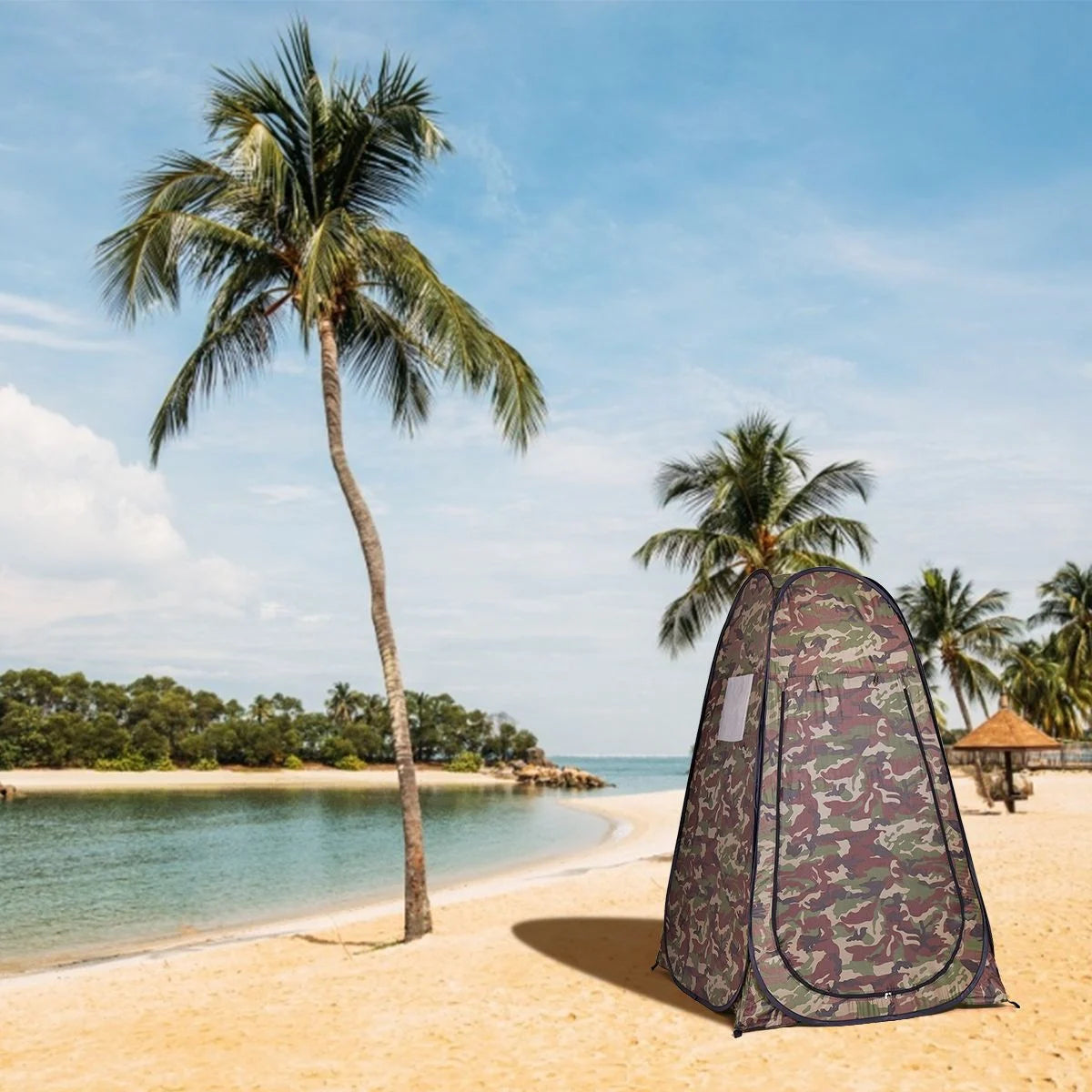 Camouflage pop-up privacy tent on tropical beach for van life camping and outdoor adventures