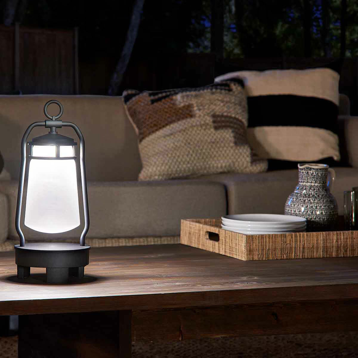 Portable LED lantern for van life and outdoor adventures, glowing on a rustic table at night